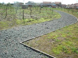 This path links the new housing to a bridge over a stream - the path on the other side of the bridge is only a rough path through grass, but doesn't have right-angled bends like this