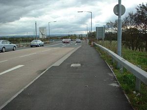 The cycle route could use this footway alongside the A725 through the Shawhead road junction